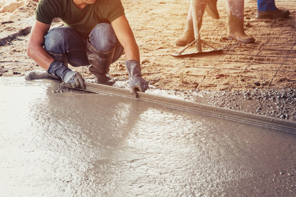 How to Choose a Reputable Concrete Construction Company: picture of cement and worker